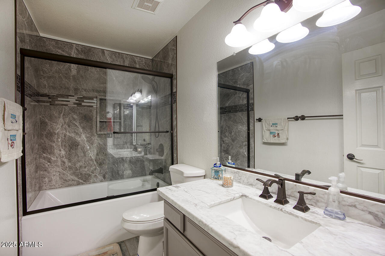 12677 North 77th Drive Peoria, AZ 85381 - Photo 18 of 25 a bathroom with a sink toilet and shower