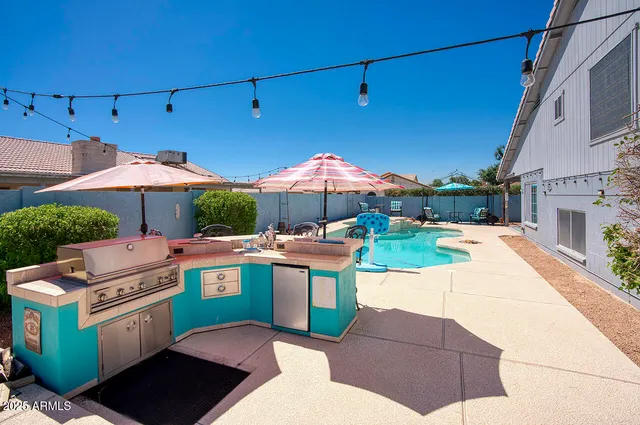 a view of a patio with a table and chairs and potted plants