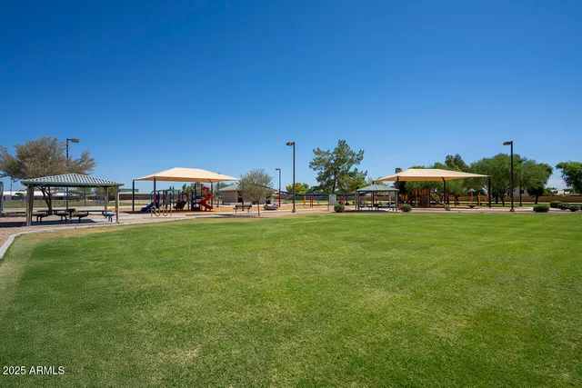 a patio with a table and chairs under an umbrella