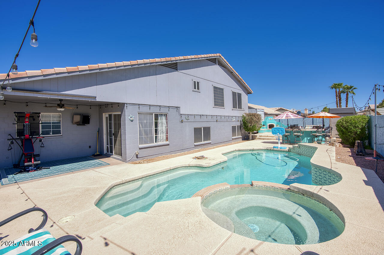12677 North 77th Drive Peoria, AZ 85381 - Photo 3 of 25 a view of a house with swimming pool