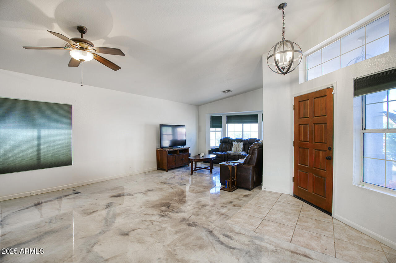 12677 North 77th Drive Peoria, AZ 85381 - Photo 4 of 25 a view of a livingroom with furniture and chandelier