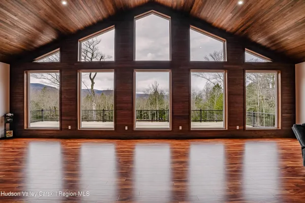 a view of a livingroom with a window and wooden floor