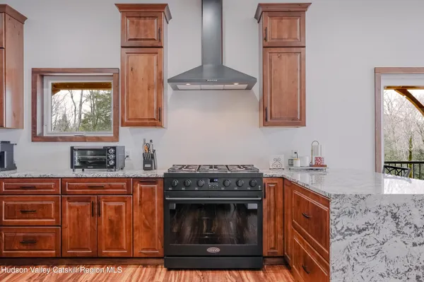a kitchen with stainless steel appliances granite countertop a refrigerator and a stove top oven