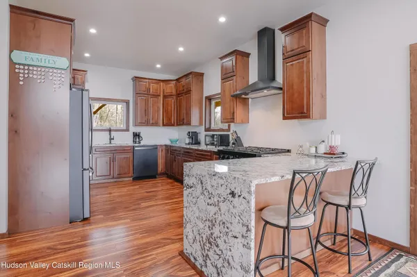 a kitchen with stainless steel appliances granite countertop a refrigerator stove and sink