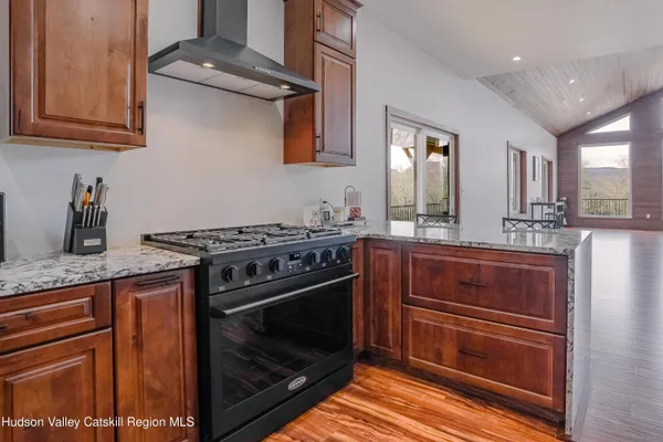 a kitchen with stainless steel appliances granite countertop a sink and cabinets