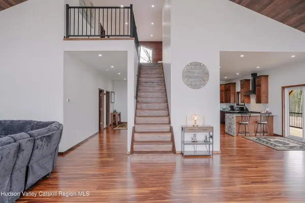 a very nice looking room with wooden floor and furniture