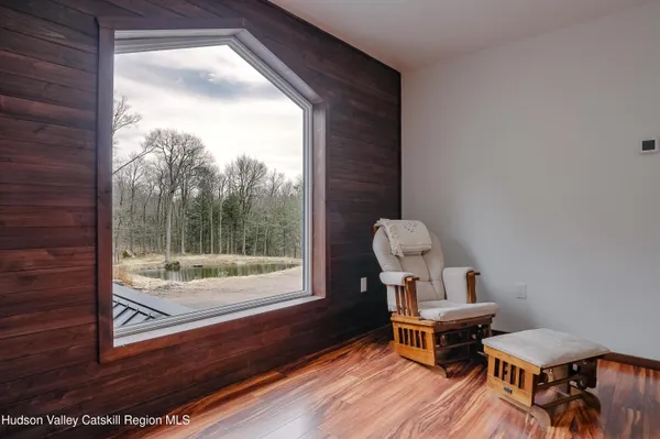 a living room with furniture window and wooden floor