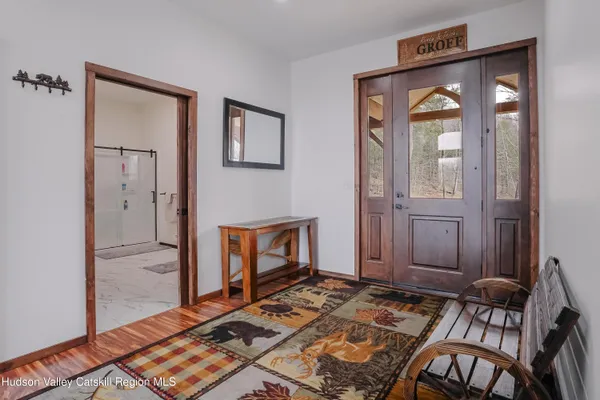 a view of room with floor to ceiling window and wooden floor
