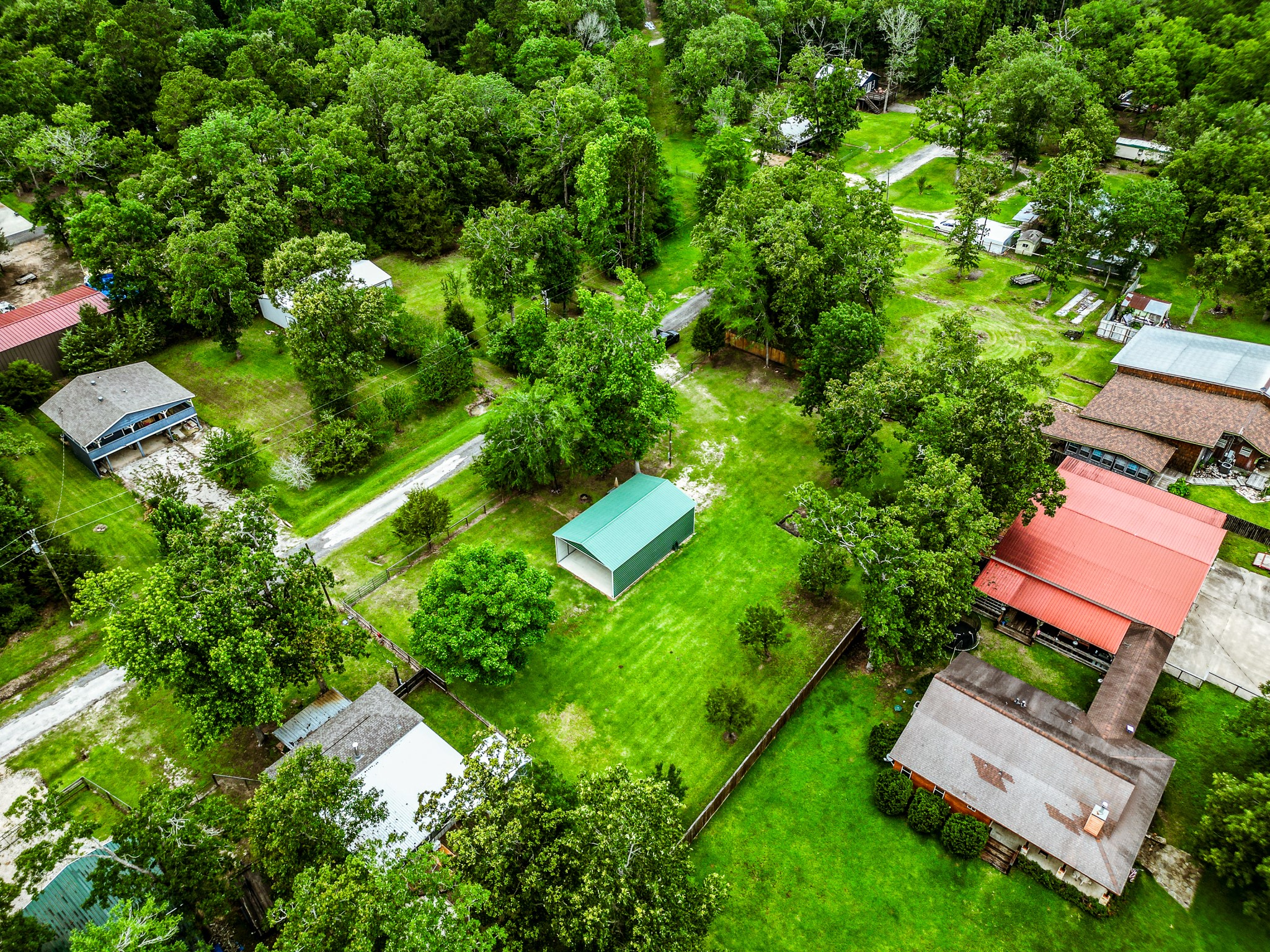 140 6th Street Trinity, TX 75862 - Photo 9 of 13 an aerial view of residential house with outdoor space and trees all around