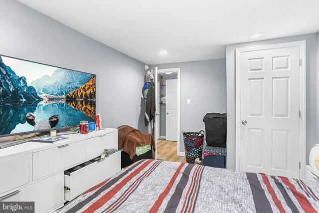 a bed room with a bed and a television