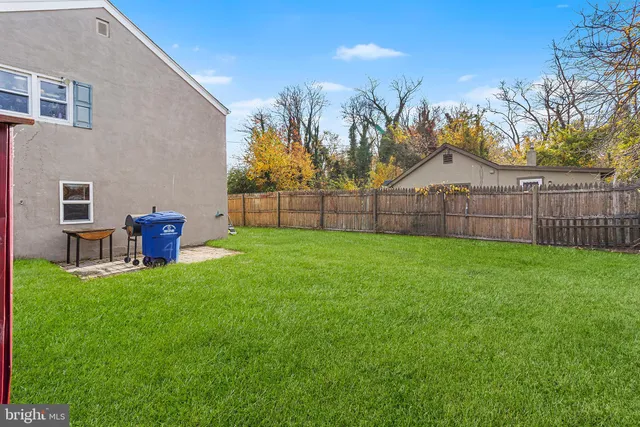 a view of a backyard with a garden and fire pit