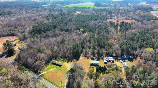 an aerial view of a houses with a yard