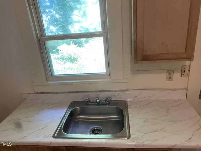 a bathroom with a sink and a window