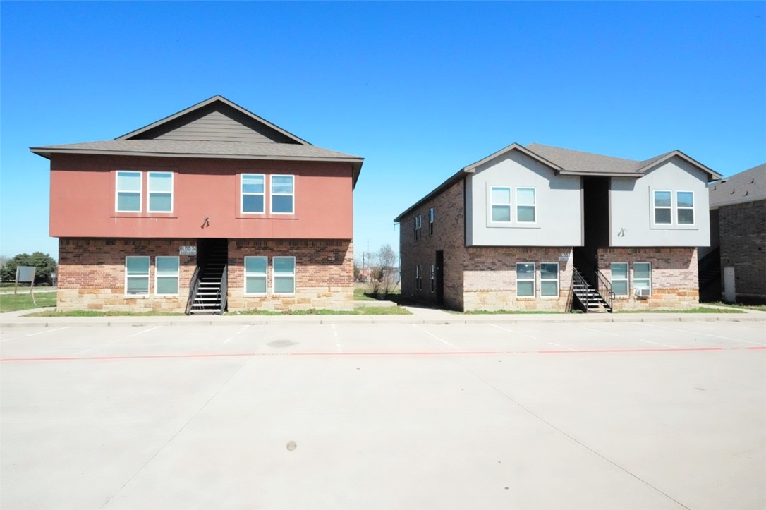 View of front of property featuring stairway and b