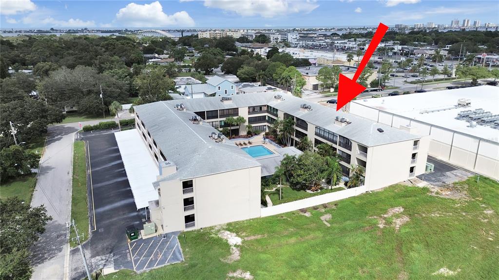 215 Valencia Boulevard, Unit 213 Largo, FL 33770 - Photo 3 of 21 a view of a house with a yard and potted plants