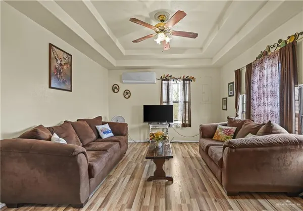 a living room with furniture and a flat screen tv