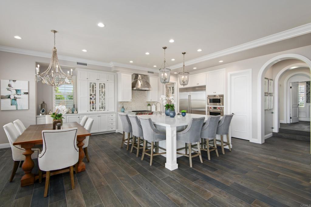 7919 Corte Penca Carlsbad, CA 92009 - Photo 5 of 7 a view of a dining room with furniture window and wooden floor