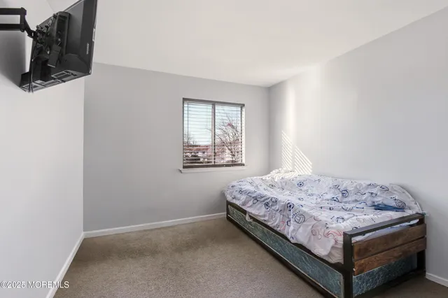 a bedroom with a bed and dresser