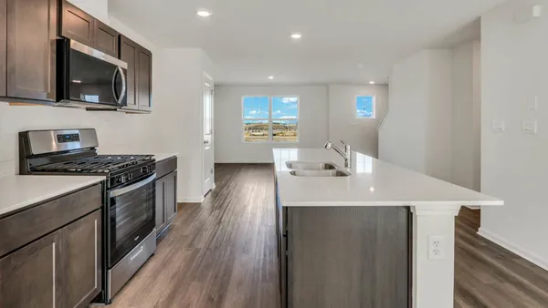 a kitchen with a sink stainless steel appliances and cabinets