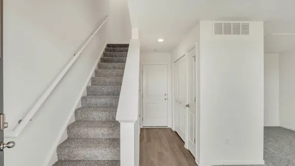 a view of staircase with white walls