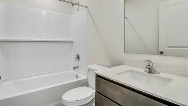 a bathroom with a sink a toilet and bathtub