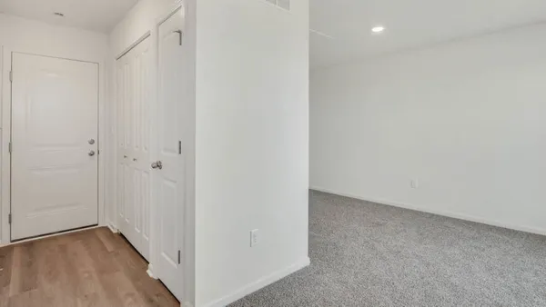 a view of hallway with wooden floor