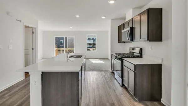 a kitchen with stainless steel appliances a sink stove and cabinets
