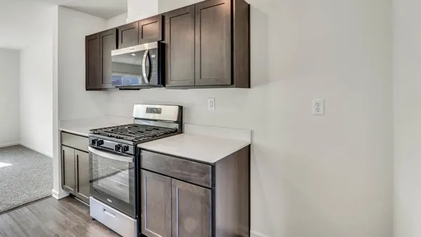 a kitchen with stainless steel appliances stove top oven and cabinets