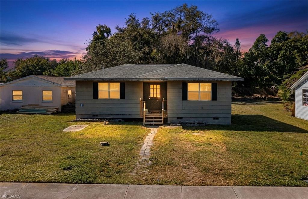 318 Bellair Road Fort Myers, FL 33905 - Photo 1 of 29 a front view of a house with a yard