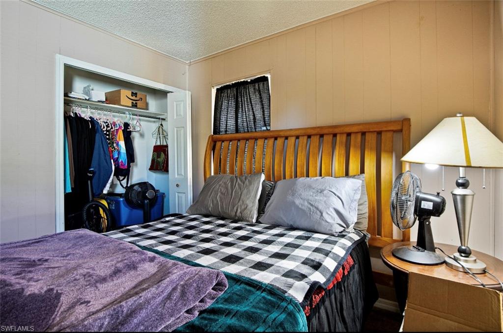 318 Bellair Road Fort Myers, FL 33905 - Photo 12 of 29 a bedroom with a bed and a dresser