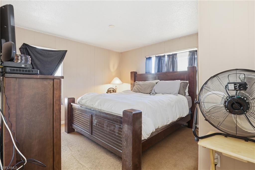 318 Bellair Road Fort Myers, FL 33905 - Photo 14 of 29 a bedroom with a bed and dresser