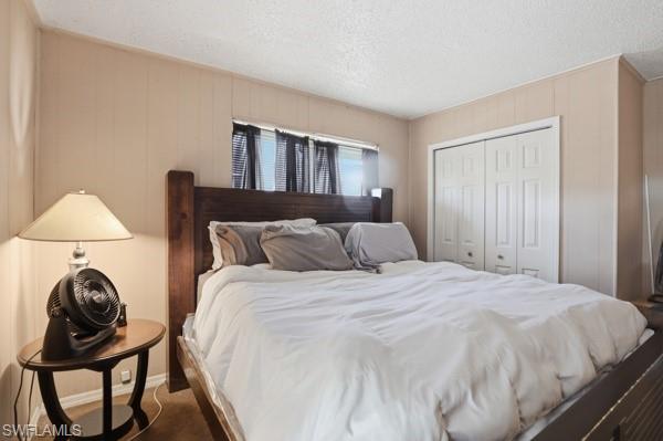 318 Bellair Road Fort Myers, FL 33905 - Photo 16 of 29 a bed sitting in a bedroom next to a window and dresser