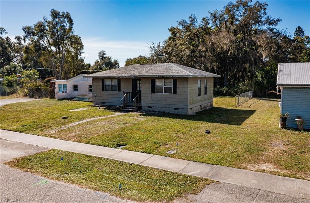 318 Bellair Road Fort Myers, FL 33905 - Photo 24 of 29 a front view of a house with a yard