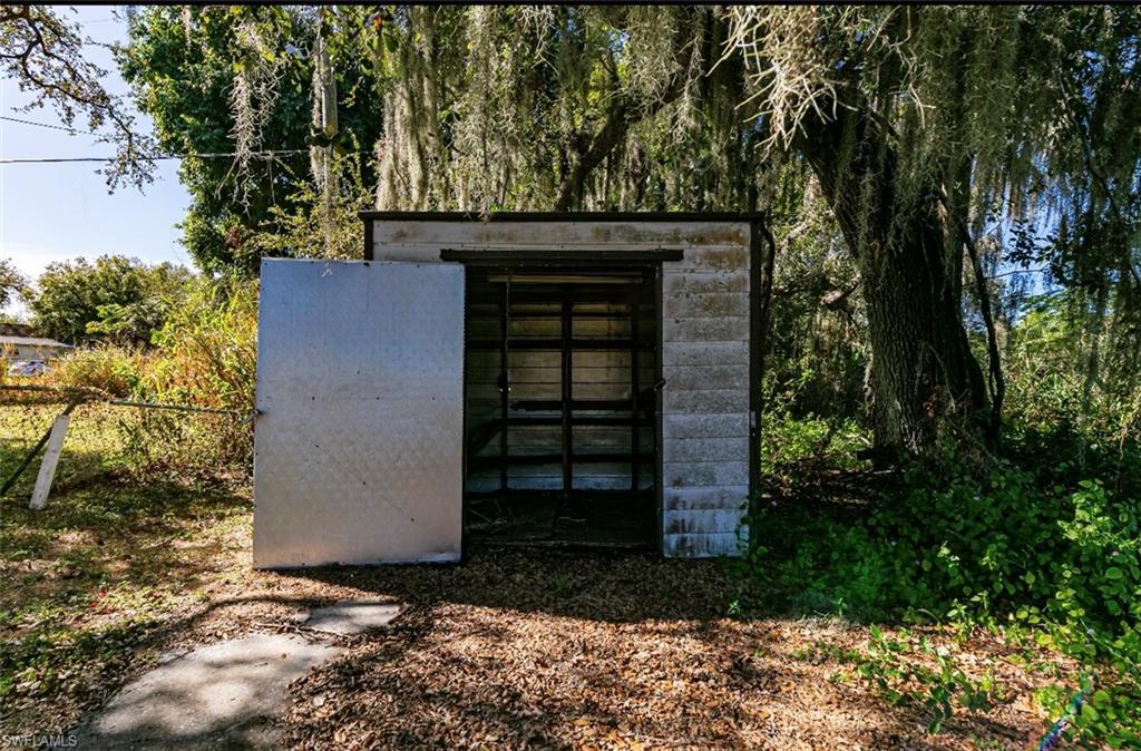 318 Bellair Road Fort Myers, FL 33905 - Photo 28 of 29 a front view of a house with a yard