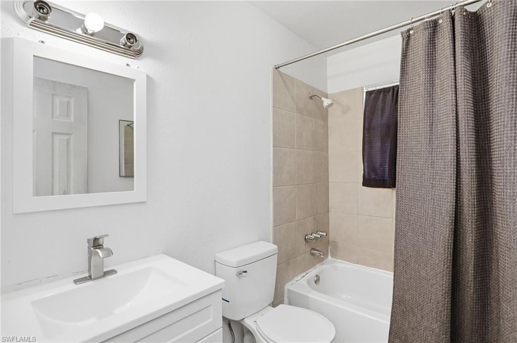 318 Bellair Road Fort Myers, FL 33905 - Photo 3 of 29 a bathroom with a sink toilet and shower