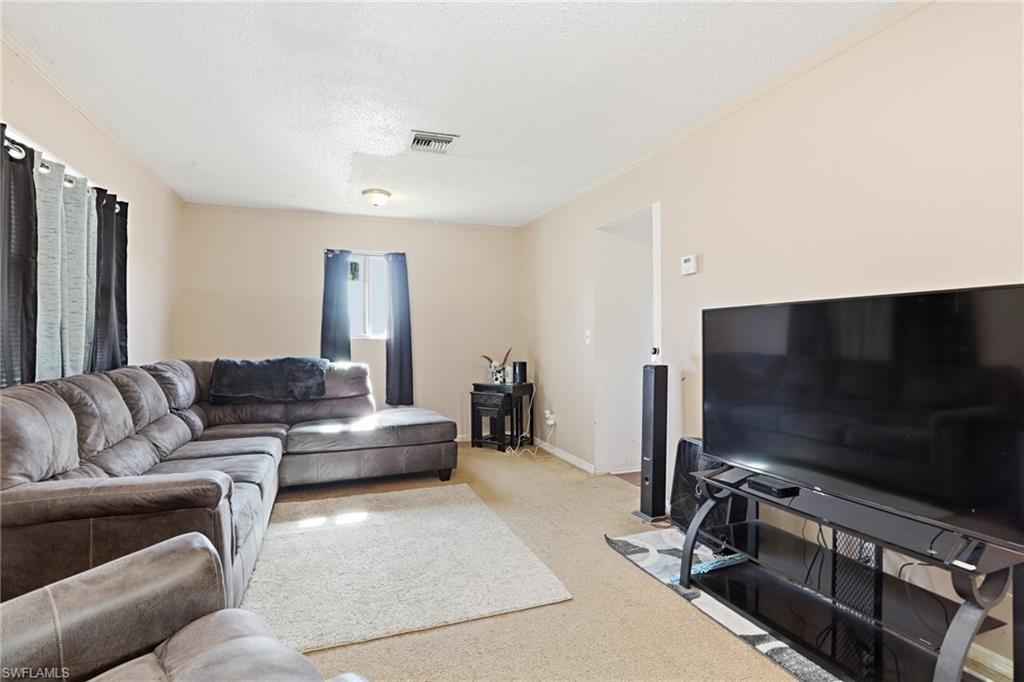 318 Bellair Road Fort Myers, FL 33905 - Photo 4 of 29 a living room with furniture and a flat screen tv