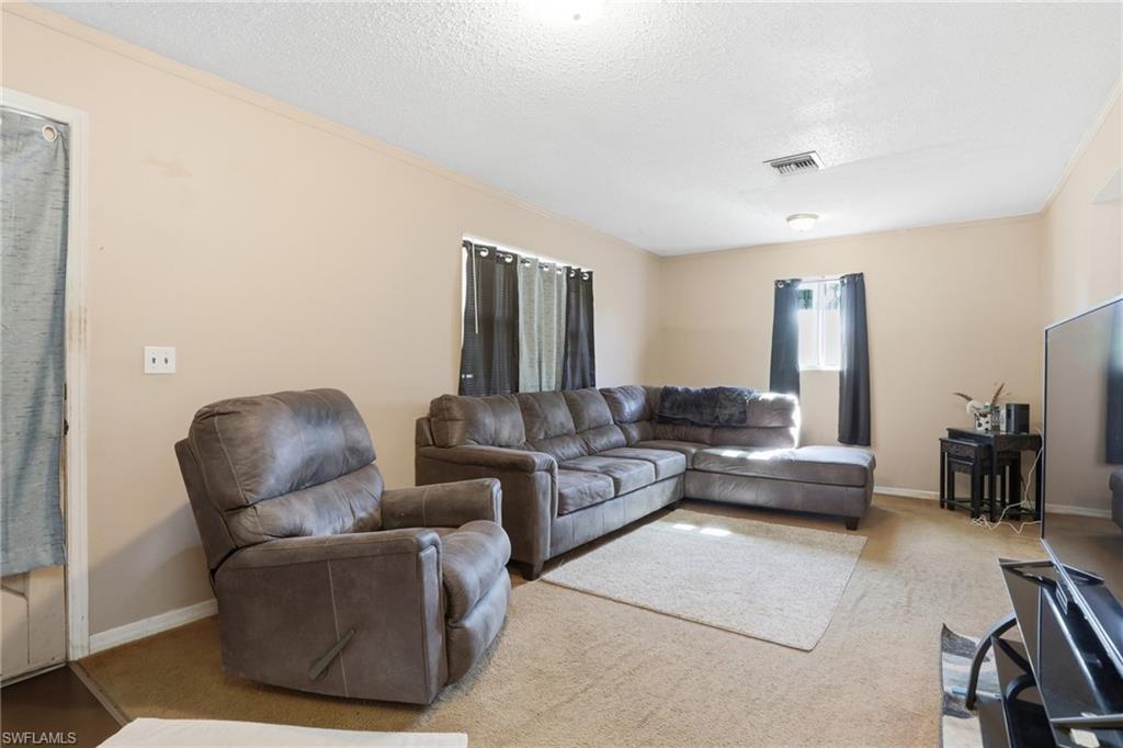 318 Bellair Road Fort Myers, FL 33905 - Photo 5 of 29 a living room with furniture and a couch
