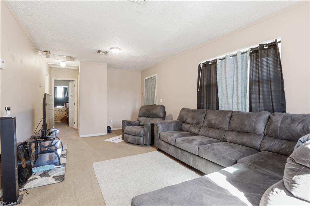 318 Bellair Road Fort Myers, FL 33905 - Photo 6 of 29 a living room with furniture and a lamp