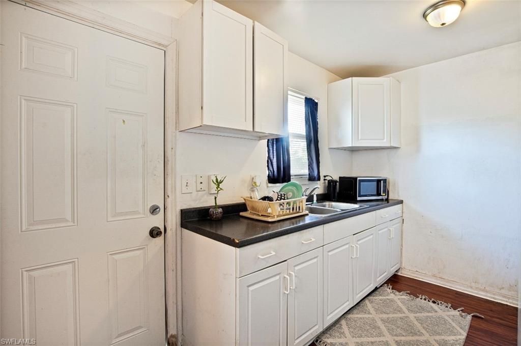 318 Bellair Road Fort Myers, FL 33905 - Photo 7 of 29 a kitchen with white cabinets and sink