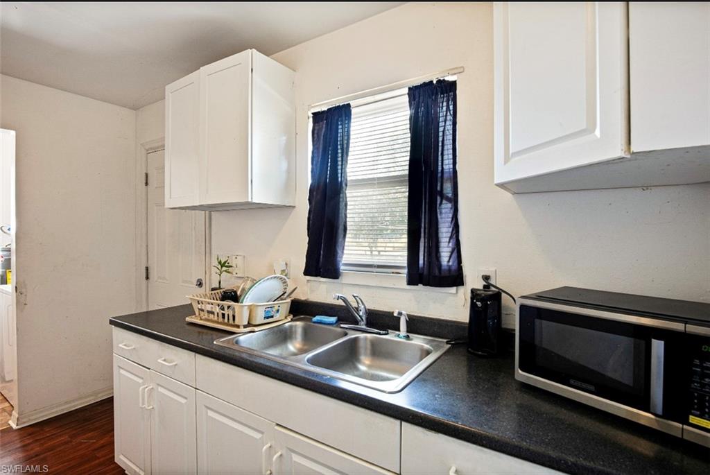 318 Bellair Road Fort Myers, FL 33905 - Photo 8 of 29 a kitchen with granite countertop stainless steel appliances a sink window and cabinets