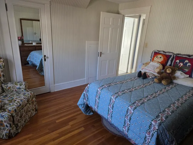 a bedroom with a bed and a mirror