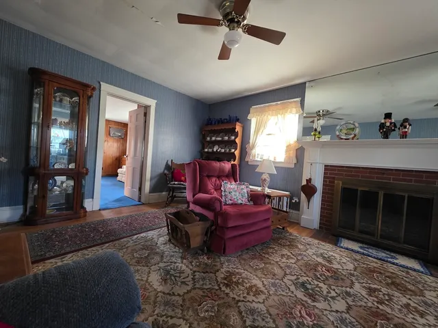 a living room with furniture and a fireplace