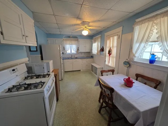 a kitchen that has a table and chairs in it