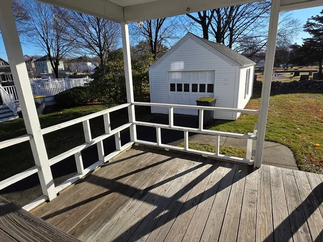 a view of balcony with wooden floor and fence