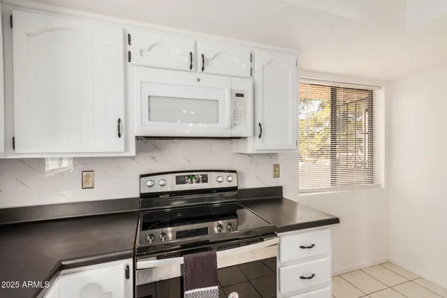 a bathroom with a granite countertop sink a mirror and a shower