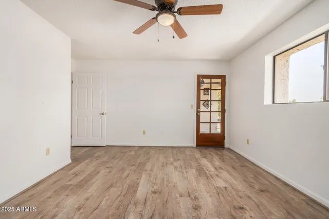 wooden floor in an empty room with a window