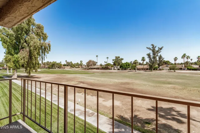 a view of a swimming pool with furniture