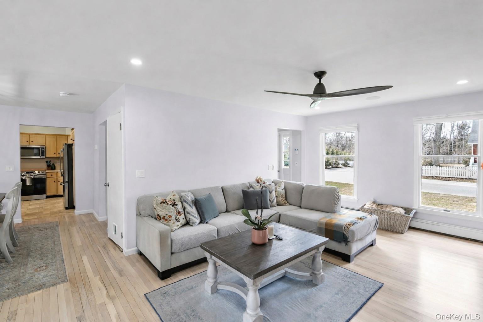5845 North Bayview Road Southold, NY 11971 - Photo 4 of 24 Spacious living room with large windows, wood floors, and adjustable recessed lighting