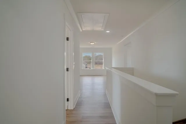 a view of hallway with wooden floor