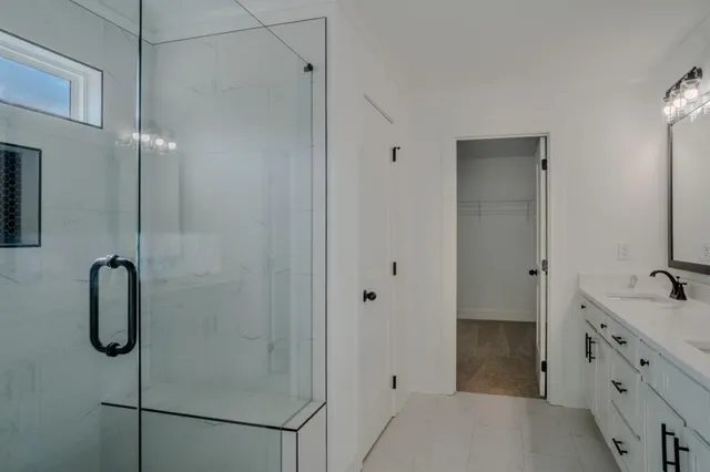 a bathroom with a shower and a sink